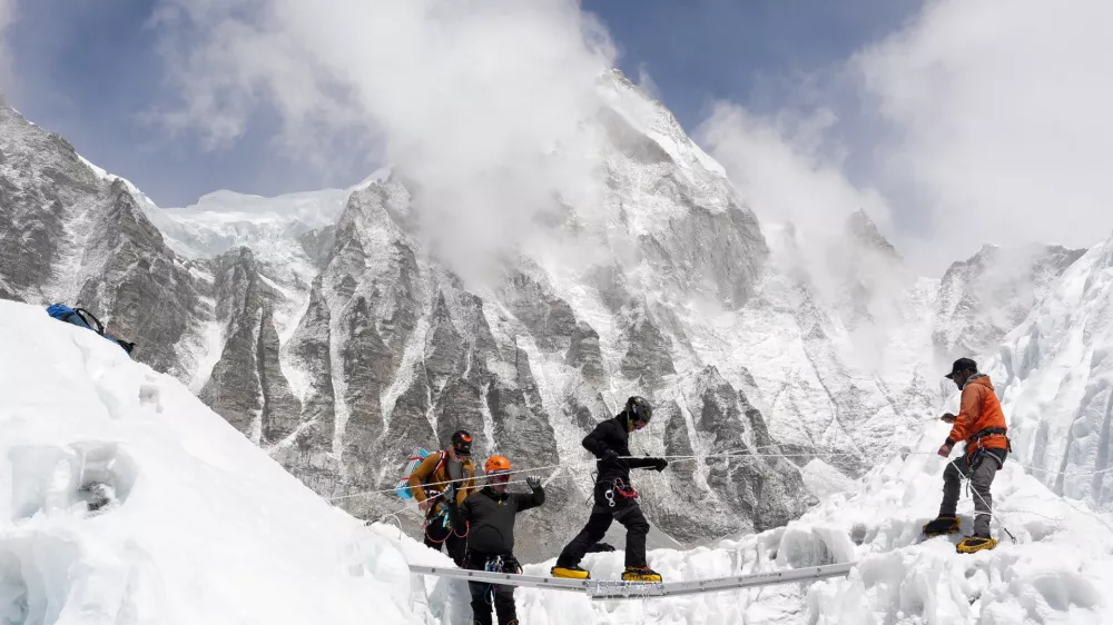 Mountaineers practice walking on a ladder during a training session at Everest base camp, Nepal April 15, 2025. REUTERS/Purnima Shrestha