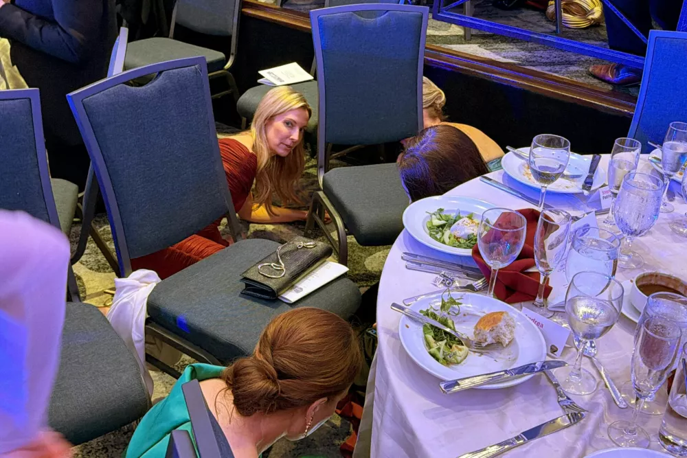 Guests take cover after U.S. President Donald Trump and first lady Melania Trump were rushed out of the White House Correspondents' Association dinner by Secret Service agents after a loud, unidentified noise, in Washington, D.C., U.S. April 25, 2026. Picture taken using a mobile phone. REUTERS/Evan Vucci