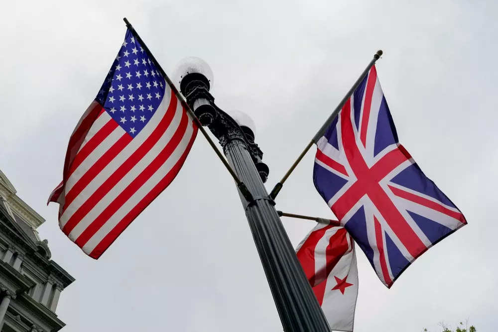 U.S., Union Jack, and Washington, D.C., flags fly in the wind near the White House ahead of Britain's King Charles and Queen Camilla's visit to the United States, in Washington, D.C., U.S., April 26, 2026. REUTERS/Elizabeth Frantz