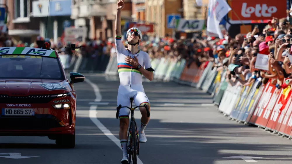 Slovenia's Tadej Pogacar of the UAE Team Emirates crosses the finish line to win the Belgian cycling classic and UCI World Tour race Liege Bastogne Liege, in Liege, Belgium, Sunday, April 26, 2026. (AP Photo/Geert Vanden Wijngaert)