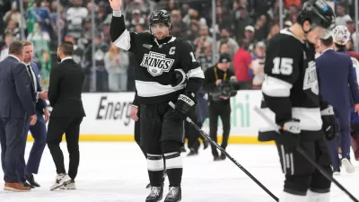 After the final game of his career, Los Angeles Kings' Anze Kopitar, center, waves to the fans following Game 4 in the first round of an NHL hockey Stanley Cup playoff series against the Colorado Avalanche, Sunday, April 26, 2026, in Los Angeles. (AP Photo/Scott Strazzante)