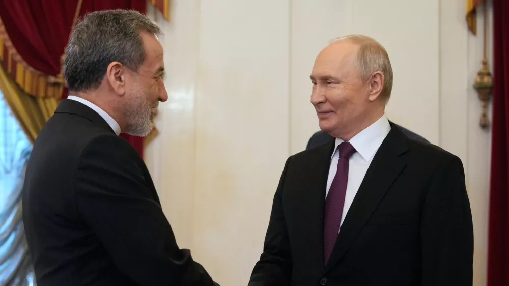 Russian President Vladimir Putin, right, shakes hands with Iranian Foreign Minister Abbas Araghchi during their meeting at the Boris Yeltsin Presidential Library, in St. Petersburg, Russia, Monday, April 27, 2026. (AP Photo/Dmitri Lovetsky, Pool)