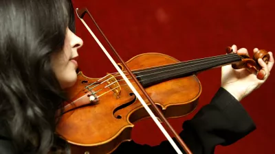 Priya Mitchell plays The Lady Tennant violin, made by Antonio Stradivari in 1699, in Christie's auction house in London, Friday March 4, 2005. The violin will be auctioned in Christie's New York Fine Musical Instruments sale on April 22, and is expected to realize between US0,000 and US.2 million (610,000-915,000).(AP Photo/John D McHugh)