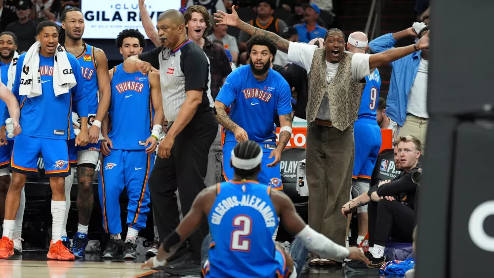 Oklahoma City Thunder guard Shai Gilgeous-Alexander (2) celebrates his score against the Phoenix Suns with teammates on the bench during the second half of Game 4 in a first-round NBA playoffs basketball series, Monday, April 27, 2026, in Phoenix. (AP Photo/Ross D. Franklin)