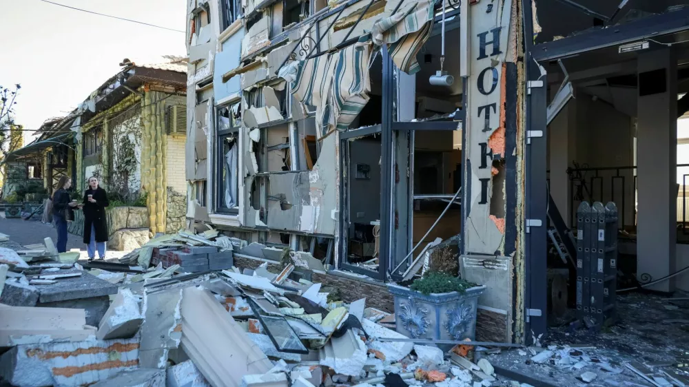 Residents stand at the site a hotel hit by a Russian drone strike, amid Russia's attack on Ukraine, in Odesa, Ukraine April 27, 2026. REUTERS/Nina Liashonok
