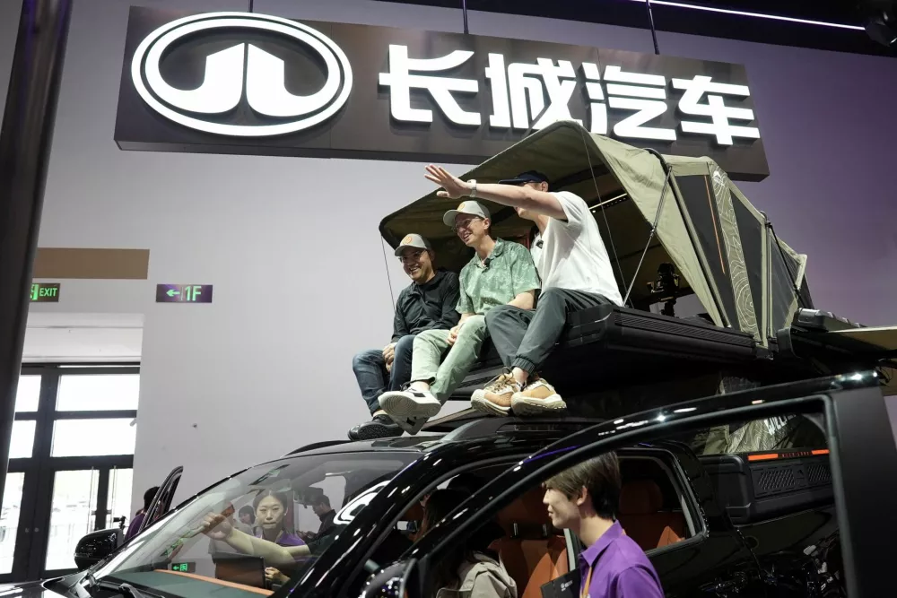 American YouTuber Ethan Robertson, 34, sits on a Great Wall Motor Hi4-T off-road vehicle as he brings foreign visitors to tour the Beijing International Automotive Exhibition, or Auto China, in Beijing, China April 26, 2026. REUTERS/Xiaoyu Yin
