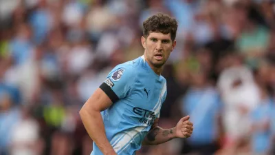 FILE - Manchester City's John Stones runs on the pitch during the English Premier League soccer match between Wolverhampton Wanderers and Manchester City at Molineux Stadium, Wolverhampton, England, Saturday, Aug. 16, 2025. (AP Photo/Dave Shopland, file)