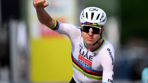 Tadej Pogacar from Slovenia raises his arms after crossing the finish line to win the first stage, a 170,6 km race around Martigny, at the 79th Tour de Romandie cycling race, in Saint-Maurice, Switzerland, Wednesday, April 29, 2026. (Laurent Gillieron/Keystone via AP)