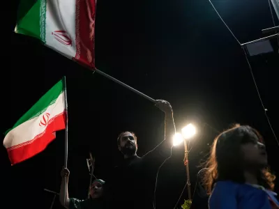 Demonstrators wave Iranian flags during a pro-government gathering at Islamic Revolution Square in Tehran, Iran, Saturday, May 30, 2026. (AP Photo/Vahid Salemi)