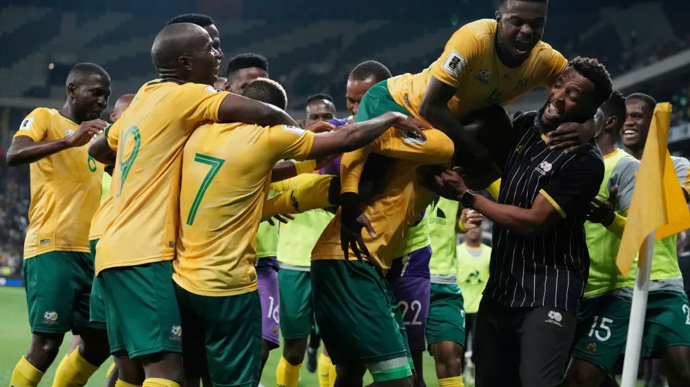 FILE - South Africa players celebrate their side's third goal during a World Cup 2026 group C qualifying soccer match between South Africa and Rwanda at Mbombela Stadium, in Nelspruit, South Africa, Oct. 14, 2025. (AP Photo/Themba Hadebe, File)