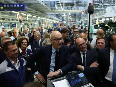 French Minister for Economy, Finance, and Industrial, Energy and Digital Sovereignty Roland Lescure, French Junior Minister in charge of Industry Sebastien Martin, and Antonio Filosa, CEO of Stellantis, listen to explanations during a visit at the Stellantis factory in Mulhouse, eastern France, June 2, 2026. REUTERS/Alice Sacco
