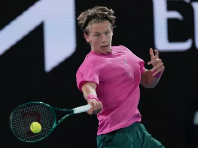 Ziga Sesko of Slovenia plays a forehand return to Keaton Hance of the U.S. during the boy's singles final at the Australian Open tennis championship in Melbourne, Australia, Sunday, Feb. 1, 2026. (AP Photo/Dar Yasin)