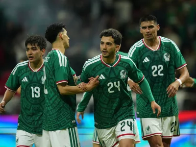 Mexico's Luis Chavez, is congratulated after scoring his side's 5th goal against Serbia during an international friendly soccer match in Toluca, Mexico, Thursday, June 4, 2026. (AP Photo/Moises Castillo)
