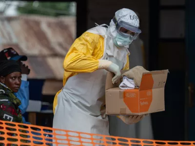 A health worker prepares for duty at the Mongbwalu treatment center in Mongbwalu, Congo, Friday, June 5, 2026. (AP Photo/Moses Sawasawa)