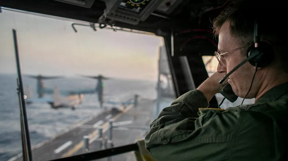 A naval officer aboard USS Tripoli (LHA 7) oversees flight operations from the control tower as the amphibious assault ship sails in the Arabian Sea. U.S. warships and aircraft deployed to the Middle East are enforcing the naval blockade against Iran while executing Project Freedom to support the free flow of commerce through the Strait of Hormuz, in this handout photo released on May 5, 2026. U.S. Navy/Handout via REUTERS  THIS IMAGE HAS BEEN SUPPLIED BY A THIRD PARTY