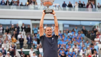 Alexander Zverev of Germany lifts the trophy after winning the men's final match against Flavio Cobolli of Italy at the French Open tennis tournament in Paris, Sunday, June 7, 2026. (AP Photo/Christophe Ena)