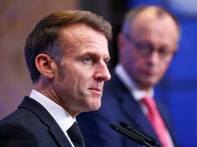 FILE PHOTO: French President Emmanuel Macron, flanked by German Chancellor Friedrich Merz, speaks during a joint press conference on the day of a Summit on European Digital Sovereignty, a high-level Franco-German meeting focused on discussing Europe's digital future, security, and independence, in Berlin, Germany, November 18, 2025. REUTERS/Christian Mang/File Photo