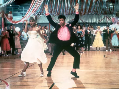 1978: Australian singer and actor Olivia Newton-John and American actor John Travolta dance in a crowded high school gym in a still from the film, 'Grease,' directed by Randal Kleiser. (Photo by Paramount Pictures/Fotos International/Getty Images)