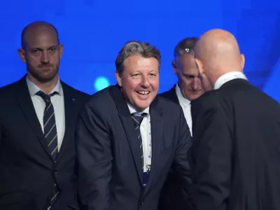 Newly chosen president of the International Ski and Snowboard Federation (FIS) Alexander Ospelt, center, speaks with former FIS president Johan Eliasch, front right, during the 57th International FIS Congress 2026, in Belgrade, Serbia, Thursday, June 11, 2026. (AP Photo/Darko Vojinovic)