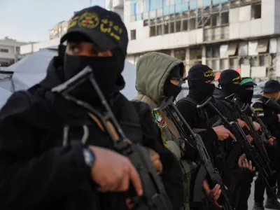 FILE - Armed Palestinian militants from Hamas and Islamic Jihad gather next to Eid al-Fitr prayers in Gaza City, March 20, 2026. (AP Photo/Abdel Kareem Hana, File)