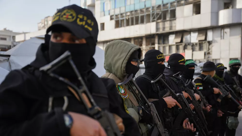 FILE - Armed Palestinian militants from Hamas and Islamic Jihad gather next to Eid al-Fitr prayers in Gaza City, March 20, 2026. (AP Photo/Abdel Kareem Hana, File)