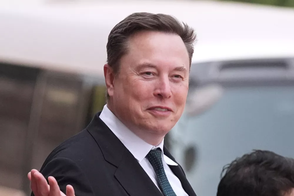 FILE - Elon Musk departs after a welcome ceremony with President Donald Trump and China's President Xi Jinping at the Great Hall of the People, Thursday, May 14, 2026, in Beijing. (AP Photo/Mark Schiefelbein, File)
