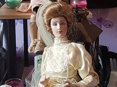 Story from Jam Press (Most Haunted Doll)Pictured: Elizabeth the doll.'I own Britain's most haunted doll &ndash; people flee the room in tears when she scratches them and pulls their hair'Visitors claim they were scratched and had their hair pulled after gathering to see a doll dubbed Britain's "most haunted".Elizabeth, a porcelain bridal doll, has already built a notorious reputation online after years of alleged paranormal incidents.But now the doll's owner, Lee Steer, says a new wave of strange encounters during two public open days has left even sceptics unsettled.The 40-year-old, who owns the Haunted Objects Museum in Rotherham, South Yorks, where the doll is kept, claims dozens of people in recent months have reported unusual experiences."Quite a few people have refused to be in the same room as Elizabeth during public museum events, especially at night," Lee, from Rotherham, South Yorks, told creatorzine.com."Some visitors feel uncomfortable almost immediately and choose to leave rather than stay near her."The incidents were spread across both days, but there did seem to be a period where activity became noticeably more concentrated, around 2pm seemed to be when the most reports started coming in."On the first day, there were cold drafts, temperature changes being picked up on the paranormal equipment, movement involving a pram, and two separate visitors claiming their hair had been pulled."On the second day, the bell-trigger equipment appeared much more active and responsive."We also had a visitor report their hair bobble being tugged, and another person noticed their bag had opened unexpectedly while near the doll."There were visitors who became overwhelmed enough to leave the room, and in some cases even step outside the building entirely to calm themselves down before returning."Once other guests started sharing their own experiences, the atmosphere naturally became much more intense, and for some people that clearly heightened the fear factor."Elizabeth, believed to be a Franklin Mint Gibson Girl bridal collector doll dating from the late 1980s, first hit headlines years ago after previous owner Debbie Merrick claimed disturbing incidents began happening in her home.According to Lee, the doll had originally been discovered in a skip before ending up in an antiques shop, where Debbie later bought it.She allegedly experienced unexplained fire alarms, moved objects and mysterious scratches before eventually listing the doll on eBay simply as a "creepy doll".Lee purchased Elizabeth for Ł866 after stumbling across the auction.He said: "For reasons I still can't fully explain, I felt drawn to the doll and decided to bid, without fully realising I was bidding on a doll that was already attracting serious press interest."Over the years, more than 30 individuals have claimed unusual experiences after being around the doll, including unexplained scratches, burns, emotional distress, strange dreams, and other unsettling incidents."Since then, Elizabeth has become one of Britain's best-known allegedly haunted objects.But Lee says the most recent incidents have been among the strangest yet.During special daytime opening events at the museum, visitors travelled from across the UK specifically to spend time near the doll.Several people reported phones freezing, restarting or refusing to record near the doll.Lee said: "Since I bought Elizabeth, lights flicker, objects move, items are knocked over, and strange disturbances happening when there's no obvious explanation."What's always stood out to me is that it often seems to happen when something new is introduced into the museum, almost like a jealous reaction."Whether that's paranormal or something else, those moments are definitely the creepiest to witness firsthand."One particularly unsettling moment involved a child's pram which visitors claimed appeared to move on its own.Another example, he claims, involved perfume bottles being "thrown across a room with force" rather than simply falling over accidentally.According to Lee, a man who had spent time around Elizabeth later collapsed during a Ouija board session in another part of the building.Lee insists he remains sceptical despite years spent investigating the doll.He said: "I think scepticism is healthy."In some cases there may well be logical explanations such as accidental scratches, environmental factors, or people simply not noticing when something happened."What makes it interesting to me is when similar reports keep coming from different people, often independently of each other."I'm not here to force a paranormal explanation on anyone, but after seeing the number of repeated claims over the years, I do think it's worth documenting and investigating rather than dismissing outright."I fully understand that in today's world, with social media, editing, and AI, people question everything and rightly so."But for me, what matters most is what I've personally seen and experienced in real life that I genuinely can't explain through normal means."Following the latest incidents, Lee says stricter rules may soon be introduced for guests entering Elizabeth's room, including requests not to provoke or mock the doll.Visitors are forbidden from touching Elizabeth.Despite the doll's sinister reputation, Lee says he has no plans to get rid of her, despite believing she could be dangerous.Lee said: "If ghosts or paranormal energy are genuinely real, then Elizabeth could potentially be dangerous simply because of the type of incidents people have associated with her over the years."It's not just scratches, it's the larger disturbances that make you think."There was even an incident at a London train station where the departure boards went down while travelling with her."That could absolutely be coincidence or bad timing, and I'm honest about that."But when you start seeing enough strange incidents stack up around one object, you naturally begin asking bigger questions."Whatever is happening around Elizabeth, whether paranormal or something else, I'm interested in understanding it rather than getting rid of her."ENDSEDITOR'S NOTE: Video Usage Licence: (EXCLUSIVE) We have obtained an exclusive licence from the copyright holder. A copy of the licence is available on request.Video Restrictions: None.,Image: 1106387403, License: Rights-managed, Restrictions: EDITOR'S NOTE: Video Usage Licence: (EXCLUSIVE) We have obtained an exclusive licence from the copyright holder. A copy of the licence is available on request.Video Restrictions: None., Model Release: no 