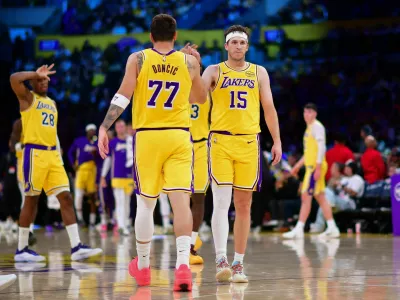 Mar 12, 2026; Los Angeles, California, USA; Los Angeles Lakers guard Luka Doncic (77) and guard Austin Reaves (15) react during the second half at Crypto.com Arena. Mandatory Credit: Gary A. Vasquez-Imagn Images