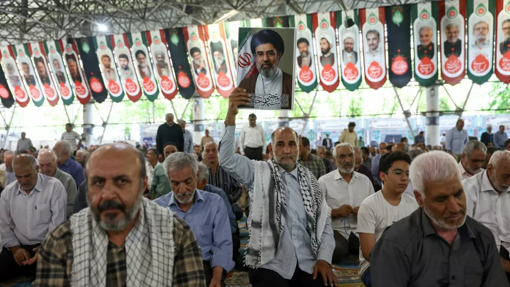 A man holds a picture of Iran's Supreme Leader, Mojtaba Khamenei, during Friday prayer in Tehran, Iran, June 12, 2026. Majid Asgaripour/WANA (West Asia News Agency) via REUTERS  ATTENTION EDITORS - THIS PICTURE WAS PROVIDED BY A THIRD PARTY. ISRAEL OUT. NO COMMERCIAL OR EDITORIAL SALES IN ISRAEL. NO ACCESS FOR ISRAELI MEDIA. NO USE BBC PERSIAN. NO USE VOA PERSIAN. NO USE MANOTO. NO USE IRAN INTERNATIONAL. NO USE RADIO FARDA. DIGITAL: NO USE BBC PERSIAN. NO USE VOA PERSIAN. NO USE MANOTO. NO USE IRAN INTERNATIONAL. NO USE RADIO FARDA.