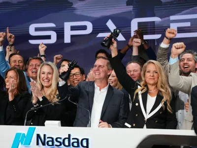 Gwynne Shotwell, President and COO of SpaceX, right, celebrates with colleagues during a bell ringing ceremony for the IPO of SpaceX at the Nasdaq MarketSite in New York, Friday, June 12, 2026, in New York. (AP Photo/Frank Franklin II)