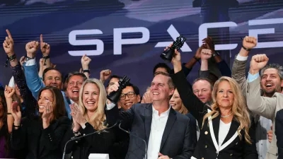 Gwynne Shotwell, President and COO of SpaceX, right, celebrates with colleagues during a bell ringing ceremony for the IPO of SpaceX at the Nasdaq MarketSite in New York, Friday, June 12, 2026, in New York. (AP Photo/Frank Franklin II)
