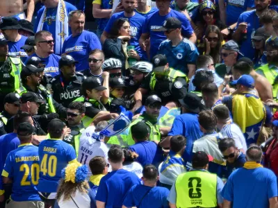 Toronto Police officers interact with Bosnia fans in the stands before the World Cup Group B soccer match between Canada and Bosnia, Friday, June 12, 2026, in Toronto. (Sammy Kogan/The Canadian Press via AP)