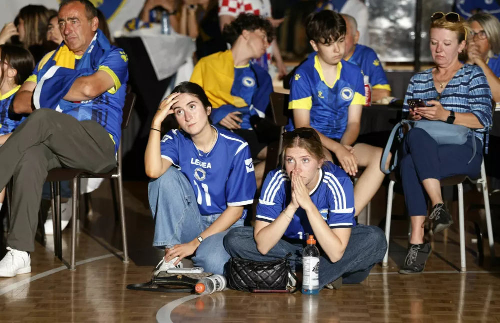 Soccer Football - FIFA World Cup 2026 - Canada v Bosnia and Herzegovina - Fans gather in Toronto - Toronto, Canada - June 12, 2026 Bosnia and Herzegovina fans react after Canada's Cyle Larin scored their first goal REUTERS/Carlos Osorio