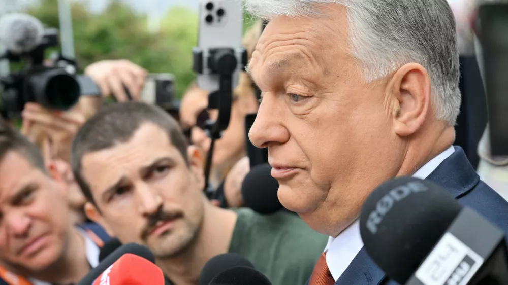 Fidesz party head and former prime minister Viktor Orban, center, speaks to the press as he arrives at the opposition Fidesz party's working congress meeting, in Budapest, Hungary, Saturday, June 13, 2026. (Zoltan Mathe/MTI via AP)