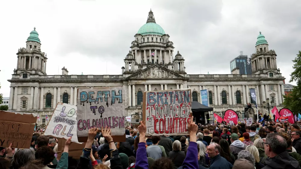 Demonstrators take part in a 'United Against Racism' rally after days of anti-immigration violence, following a knife attack on June 8, which left a man seriously injured and prompted police to declare a critical incident, outside the Belfast City Hall, in Belfast, Northern Ireland, June 13, 2026. REUTERS/Isabel Infantes