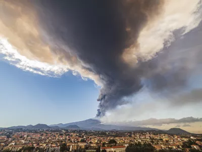 Volcanic ashes ascend from the southeastern crater of the Mt. Etna volcano as seen from Pedara, Sicily, Italy, Monday, Feb. 21, 2022. The second-strongest paroxysm of 2022 produced volcanic smoke and ashes that rose for 10 kilometers (6.2 miles) forcing the temporary closure of the nearby Vincenzo Bellini international airport in Catania. (AP Photo/Salvatore Allegra)