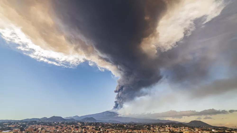 Volcanic ashes ascend from the southeastern crater of the Mt. Etna volcano as seen from Pedara, Sicily, Italy, Monday, Feb. 21, 2022. The second-strongest paroxysm of 2022 produced volcanic smoke and ashes that rose for 10 kilometers (6.2 miles) forcing the temporary closure of the nearby Vincenzo Bellini international airport in Catania. (AP Photo/Salvatore Allegra)