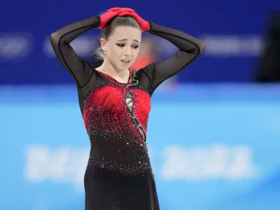 Kamila Valieva, 15, of the Russian Olympic Committee, reacts after the women's team free skate program during the figure skating competition at the 2022 Winter Olympics, Monday, Feb. 7, 2022, in Beijing. The 2022 Games' first major scandal has managed to involve the 15-year-old figure skater who has tested positive for using a banned heart medication that may cost her Russia-but-not-really-Russia team a gold medal in team competition. Kamila Valieva continues to train even as her final disposition is considered, and she may yet compete in the women's individual competition, in which she is favored. (AP Photo/Natacha Pisarenko)