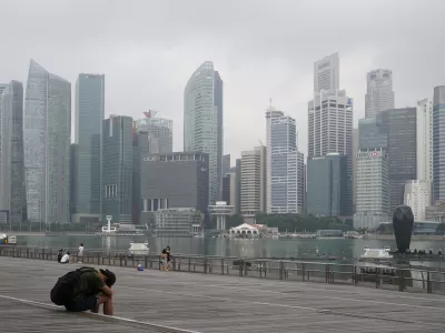 FILE - A man takes a nap as the central business district is shrouded by haze in Singapore, on Sept. 23, 2019. Singapore executed a man Wednesday, July 26, 2023, for drug trafficking and is set to hang a woman Friday &mdash; the first in 19 years &mdash; prompting renewed calls for a halt to capital punishment. (AP Photo/Vincent Thian, File)