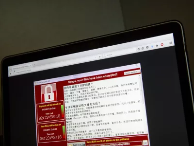 A screenshot of the warning screen from a purported ransomware attack, as captured by a computer user in Taiwan, is seen on laptop in Beijing, Saturday, May 13, 2017. Dozens of countries were hit with a huge cyberextortion attack Friday that locked up computers and held users' files for ransom at a multitude of hospitals, companies and government agencies. (AP Photo/Mark Schiefelbein)