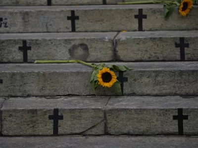 Sunflowers and crosses cover the City Council steps during a protest against femicide on International Women's Day in Rio de Janeiro, Brazil, Friday, March 8, 2024. (AP Photo/Silvia Izquierdo)