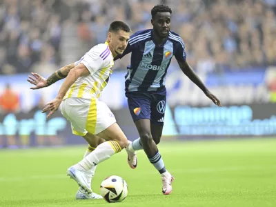 Maribor's Gregor Sikosek, left, and Djurg&aring;rden's Tokmac Nguen challenge for the ball during the Conference League playoff first leg soccer match between Djurgardens IF and NK Maribor at Stockholm Arena, in Stockholm, Sweden, Thursday, Aug. 22, 2024. (Magnus Lejhall/TT News Agency via AP)