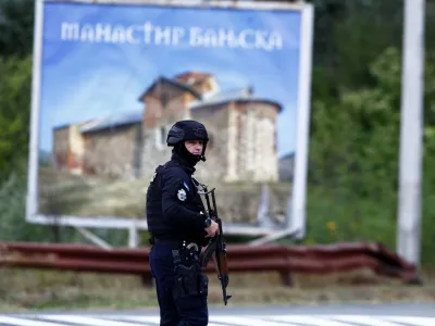 A Kosovo police officer stands guard on a road to Banjska monastery, in the aftermath of a shooting incident, near Zvecan, Kosovo September 25, 2023. REUTERS/Ognen Teofilovski